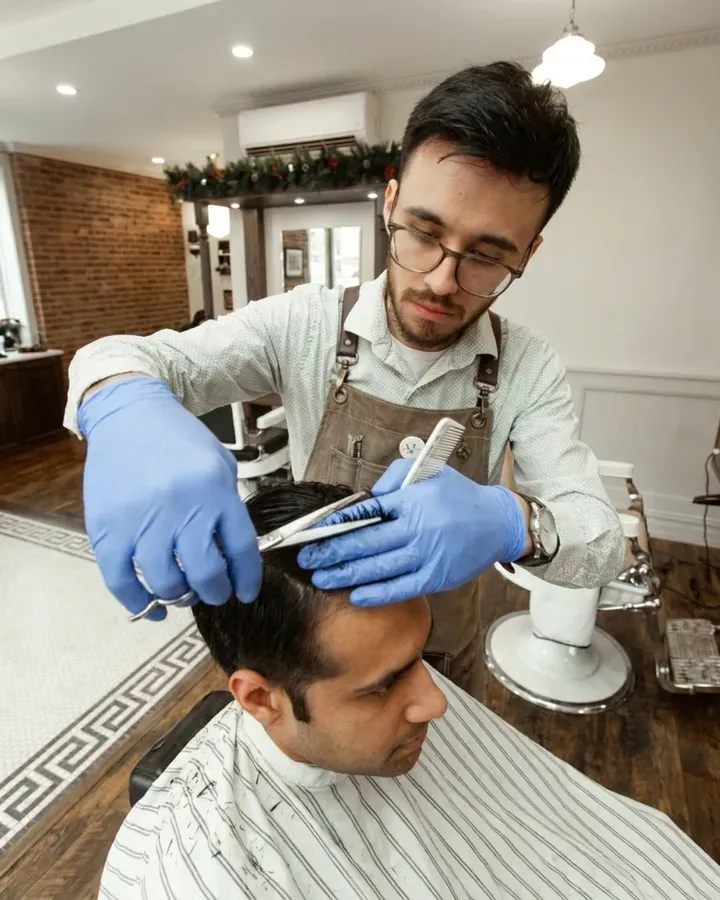 A barber cutting a customer's hair